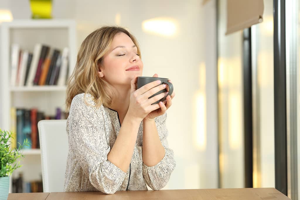 woman enjoying a cup of tea - habits to live more intentionally