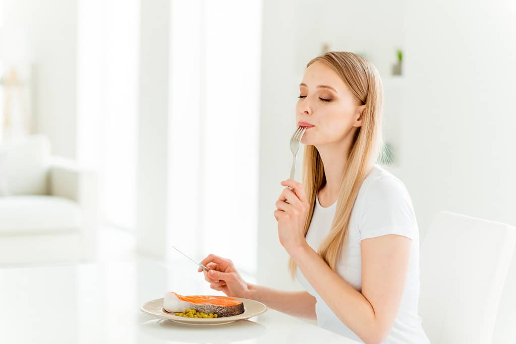 woman enjoying and savoring her meal - habits to live more intentionally