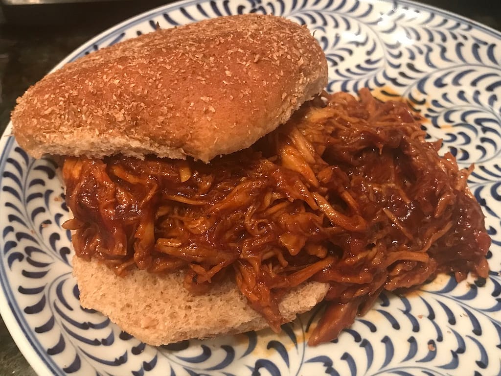 pulled BBQ chicken on bun, ready to eat