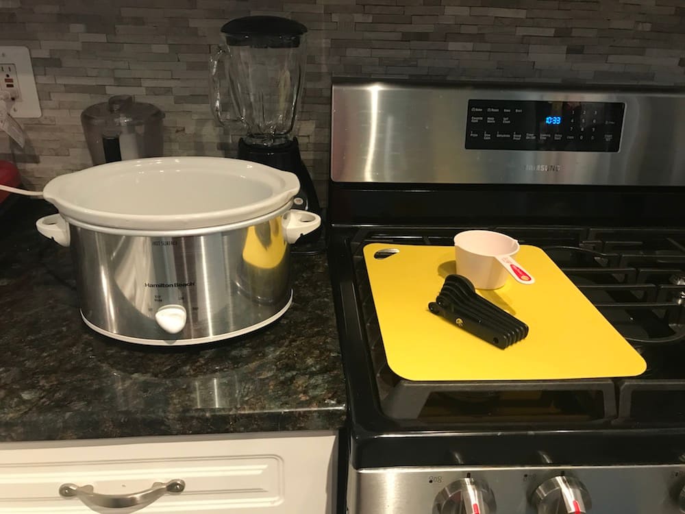 slow cooker and mat in kitchen, ready for food prep